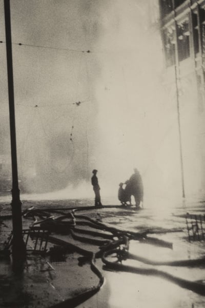 Men hosing down a fire to a building during the Blitz of 1941 in Plymouth
