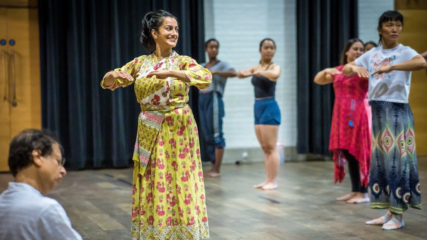 A group of adults taking part in a Kathak dance workshop