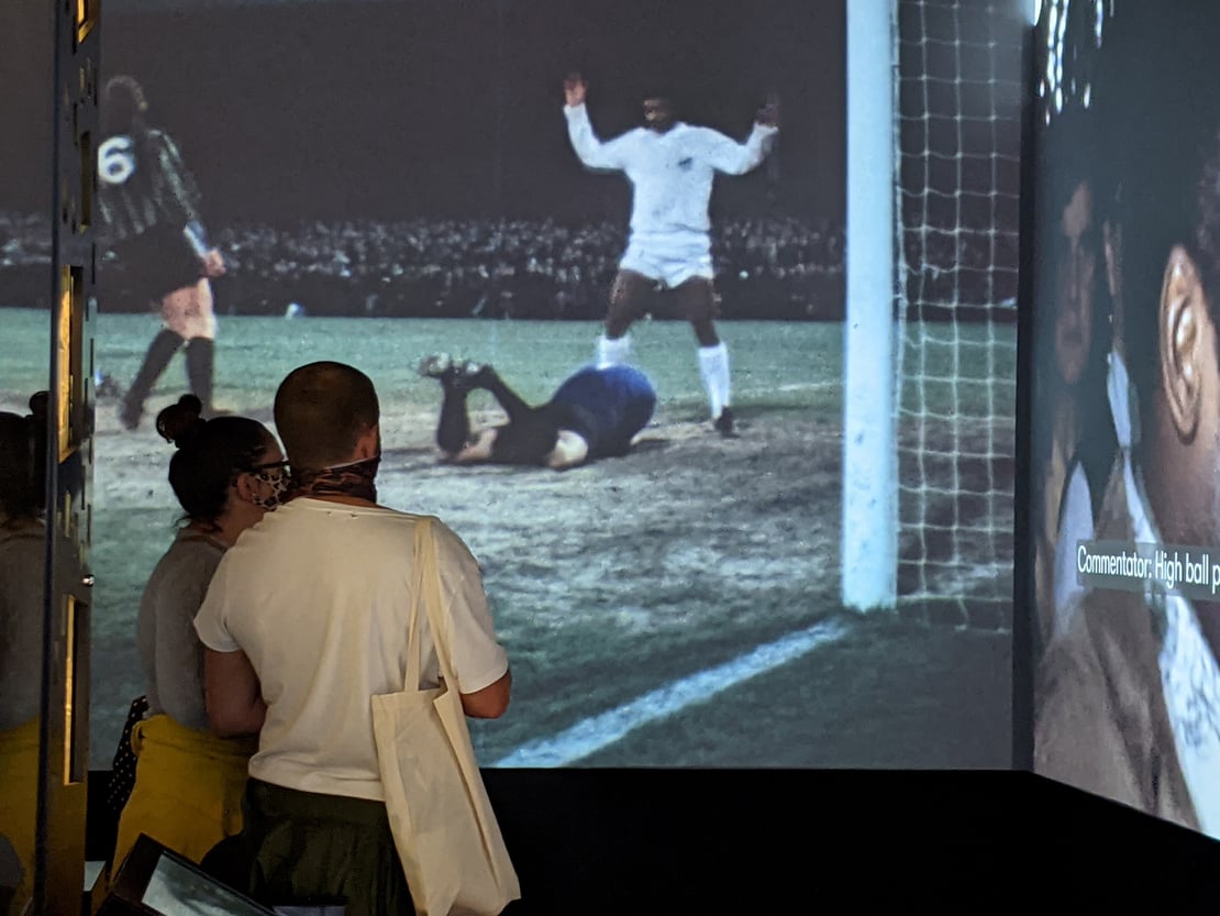 Visitors looking at a film projection in The Box's Media Lab