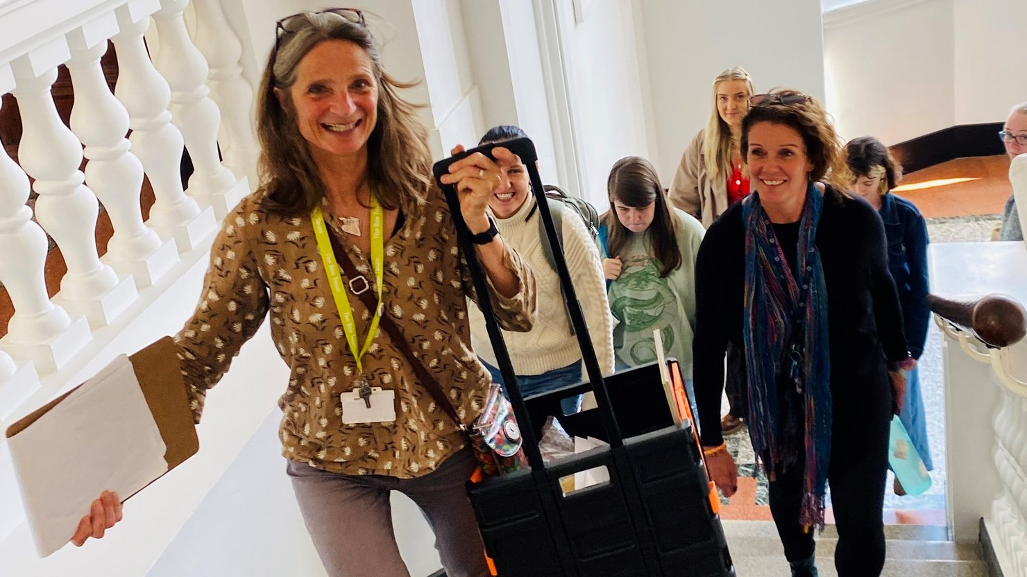 A group of happy people walking up a flight of stairs