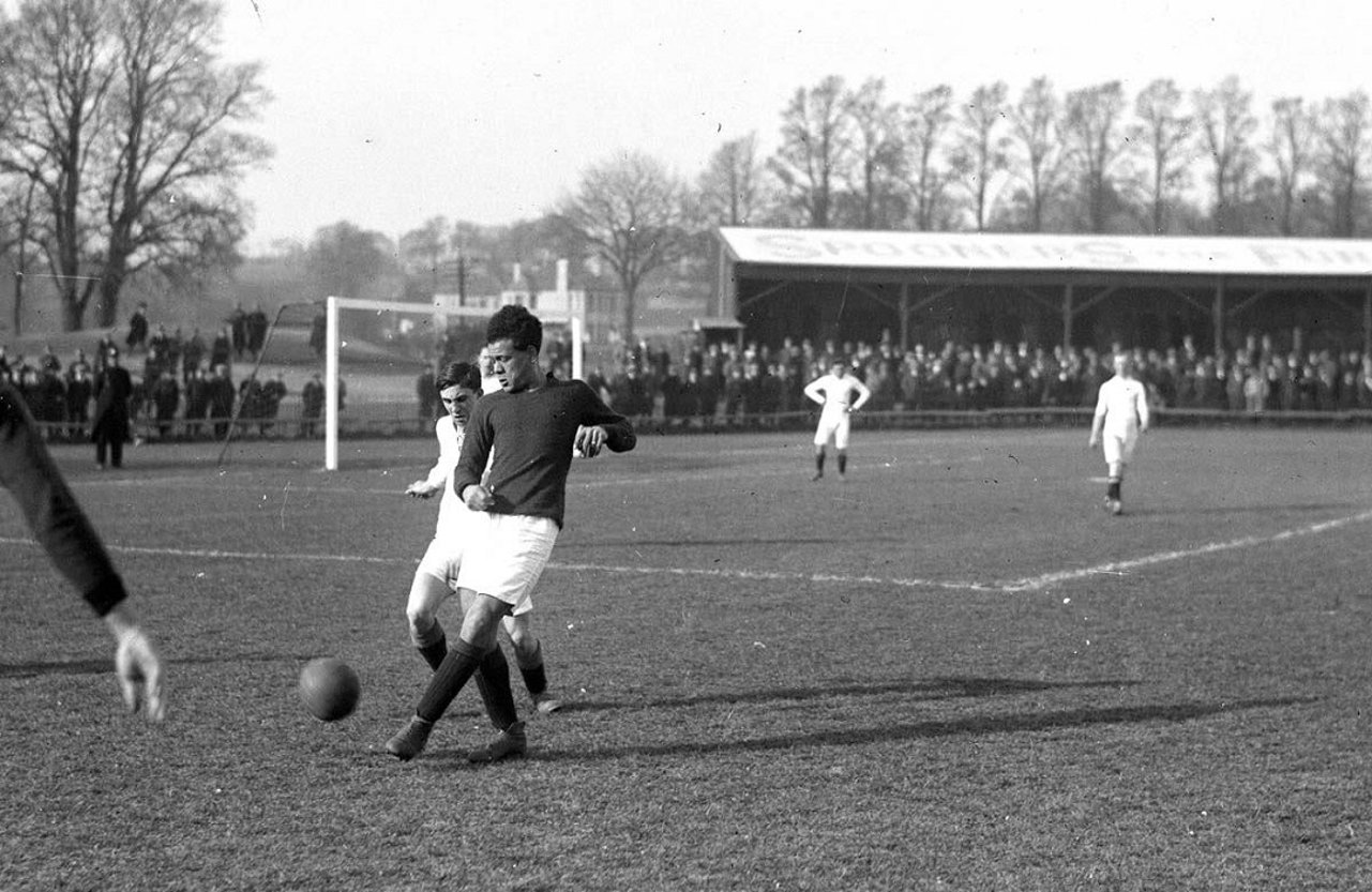 Black and white photograph showing a football match