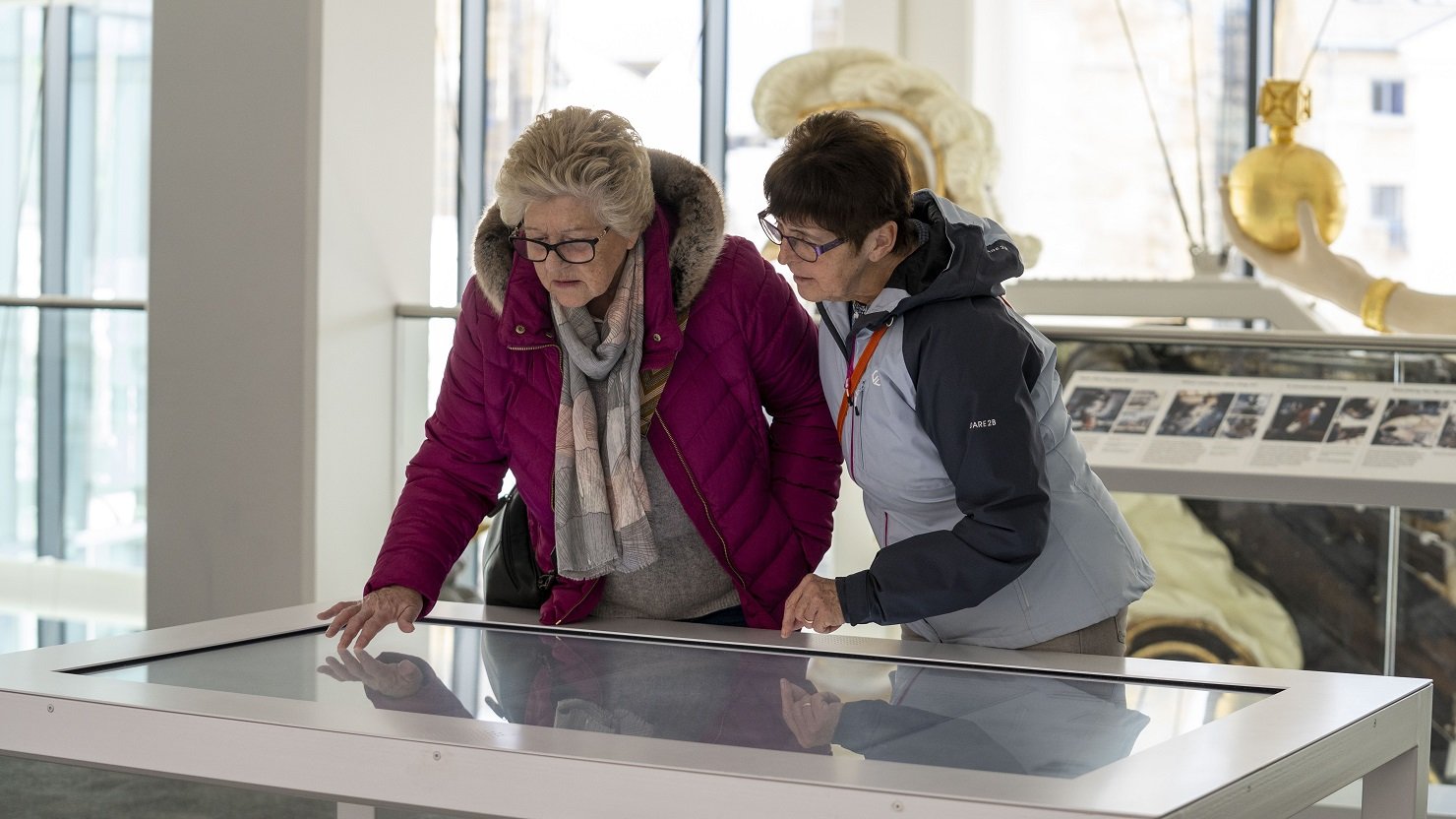 Two women look at the Map Table at The Box, Plymouth