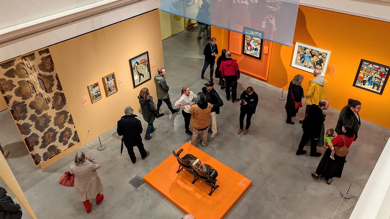Photograph showing an aerial shot of visitors looking around an exhibition.