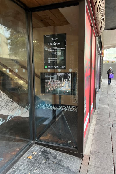 Film screen in the window of empty restaurant in Plymouth