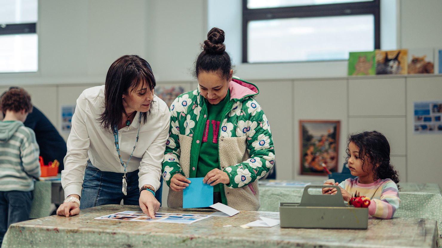 Adults and a young child take part in a workshop at The Box Plymouth