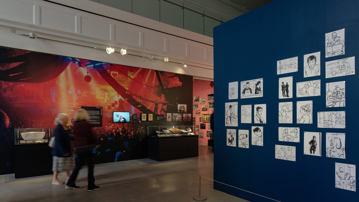 A visitor looking at the 'because the night belongs to us' exhibition