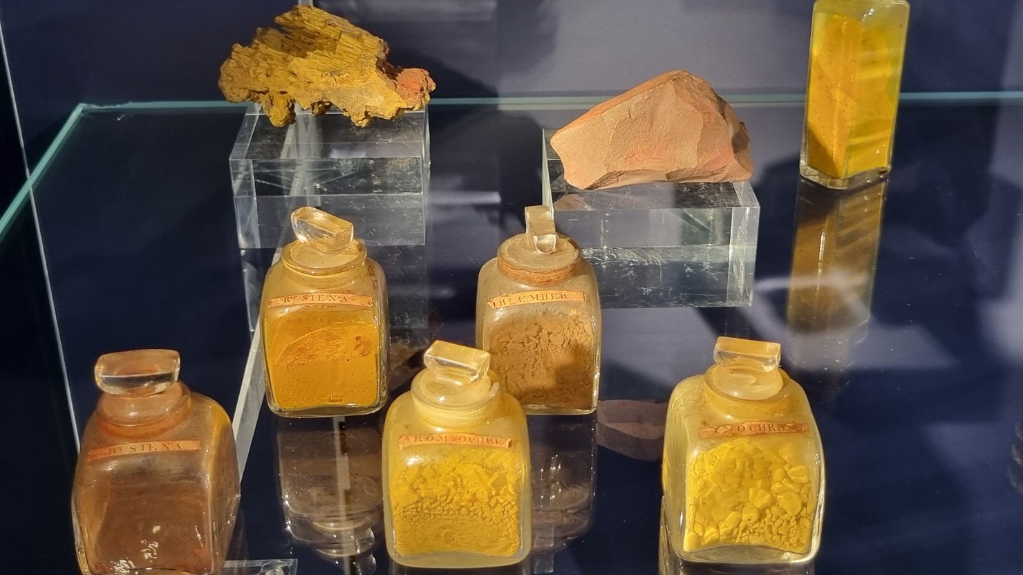 Limonite, Ochre, Sienna and Umber in bottles on a shelf