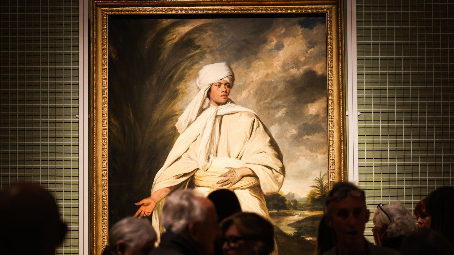 Visitors to The Box Plymouth standing in front of Portrait of Mai (Omai) by Sir Joshua Reynolds.