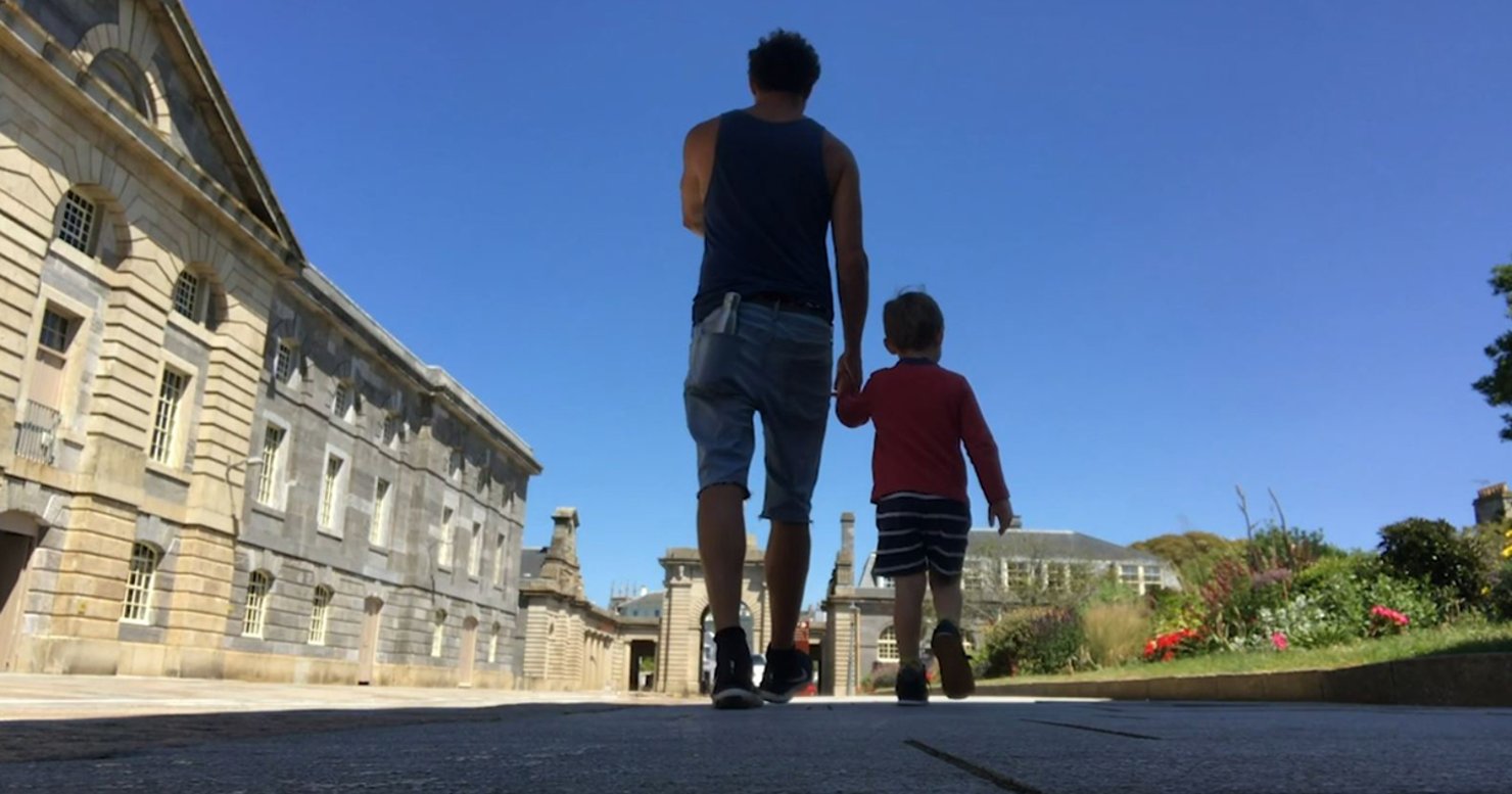 Andy Quick walking through the Royal William Yard with his young son