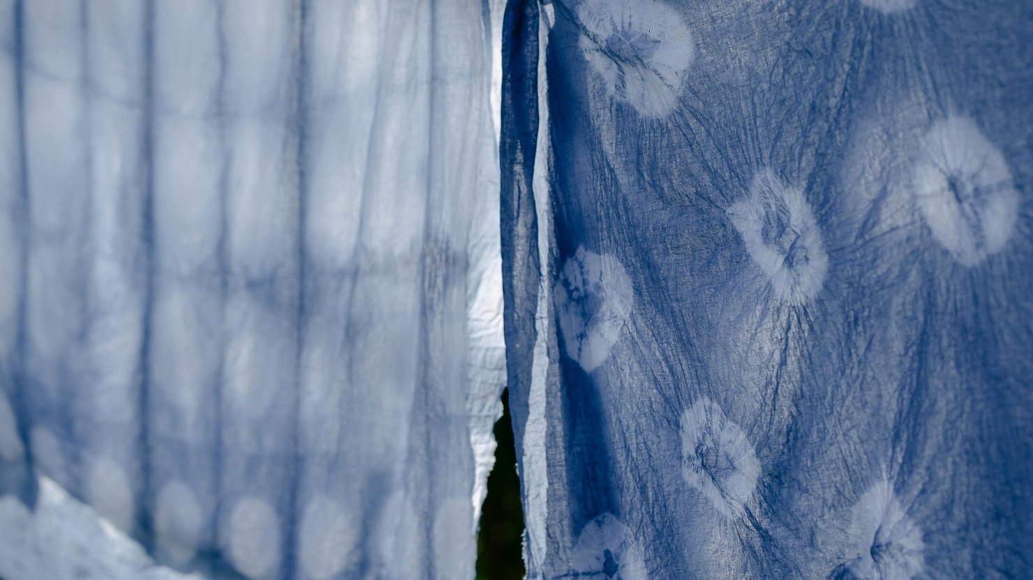 Two different pieces of blue and white tie-dyed fabric