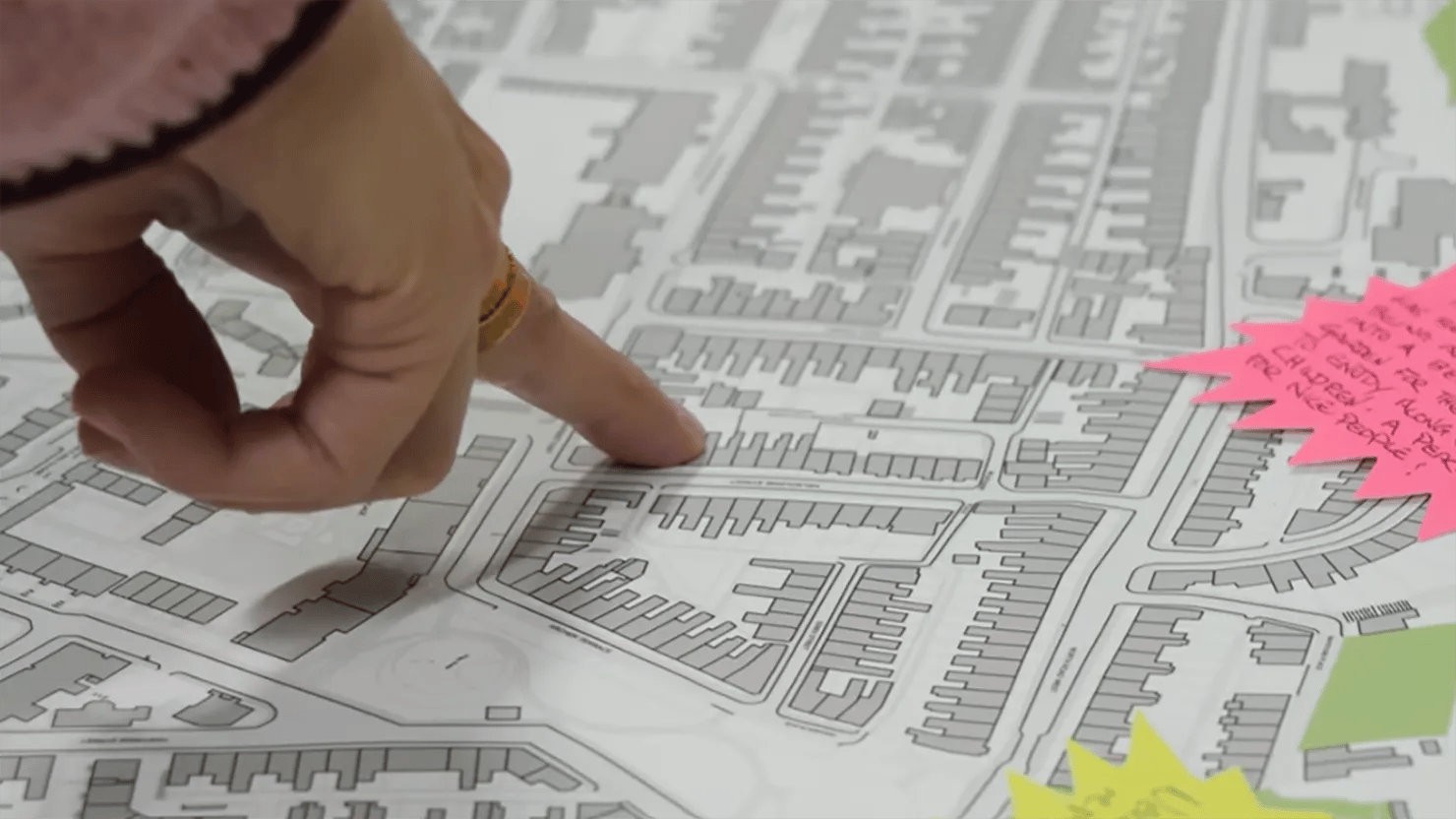 Photo showing a hand pointing at a street plan