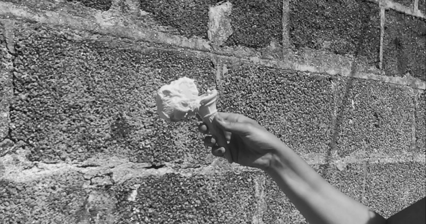 A still from Grace Lightman's music commission featuring an ice cream just about to hit a wall