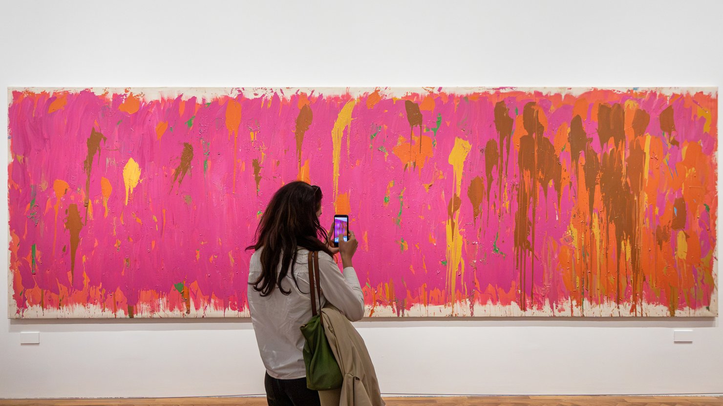 A visitor to The Box Plymouth looking at Untitled (Cerise) by Gillian Ayres