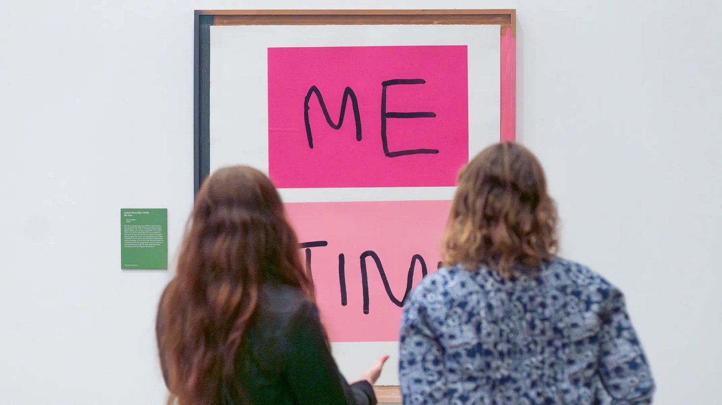 Photograph showing two women looking at a large print saying 'Me time'