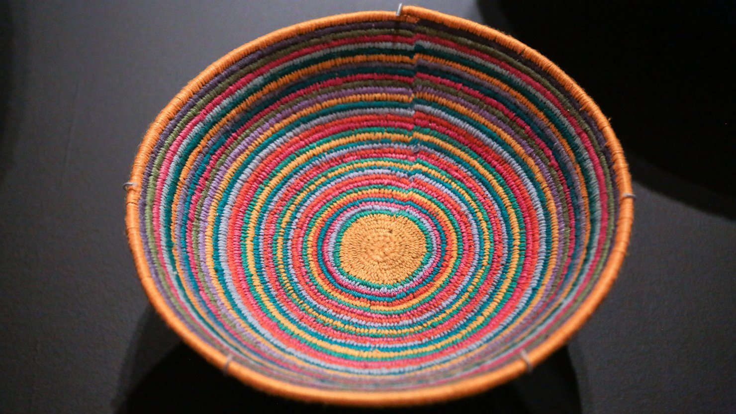 Close up of a brightly coloured woven basket