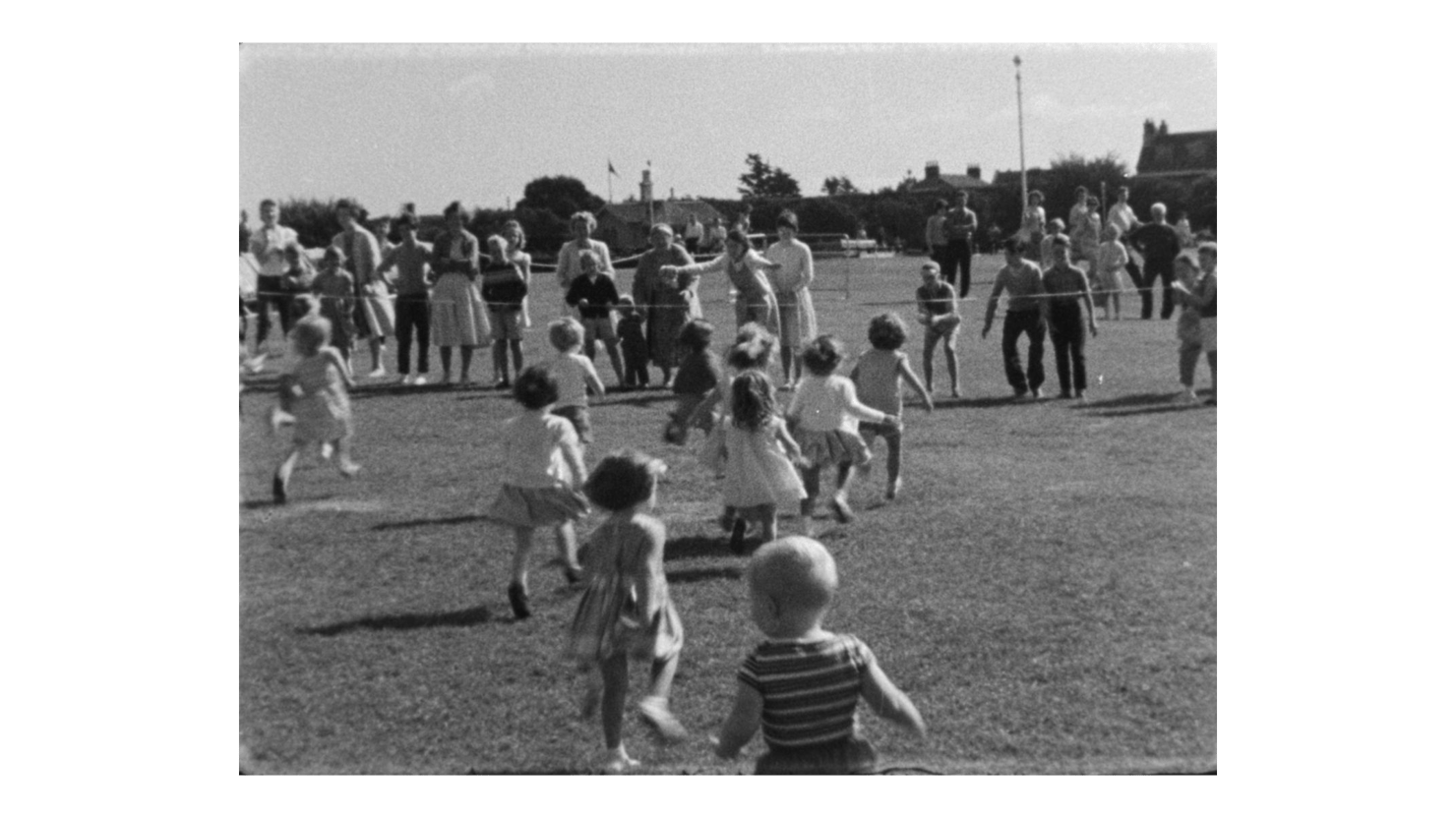 Still from black and white film showing a school sports day