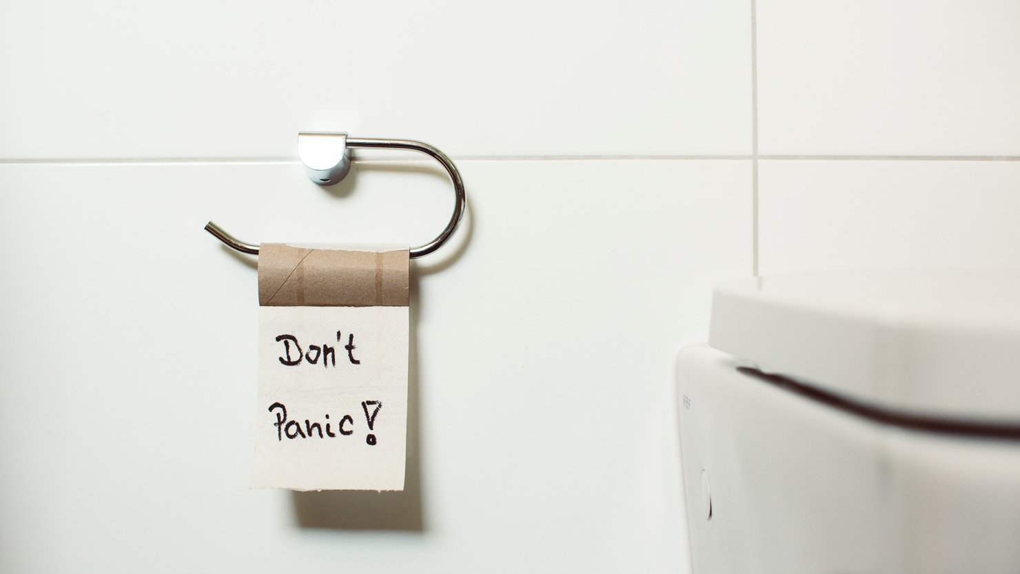 Don't panic sign on a toilet roll holder