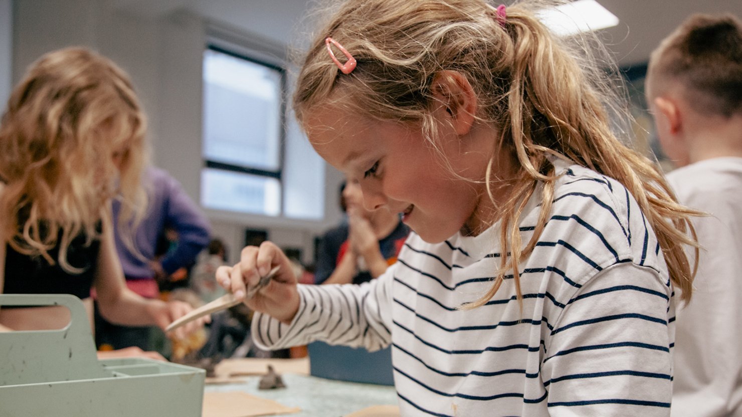 A happy girl taking part in a craft activity