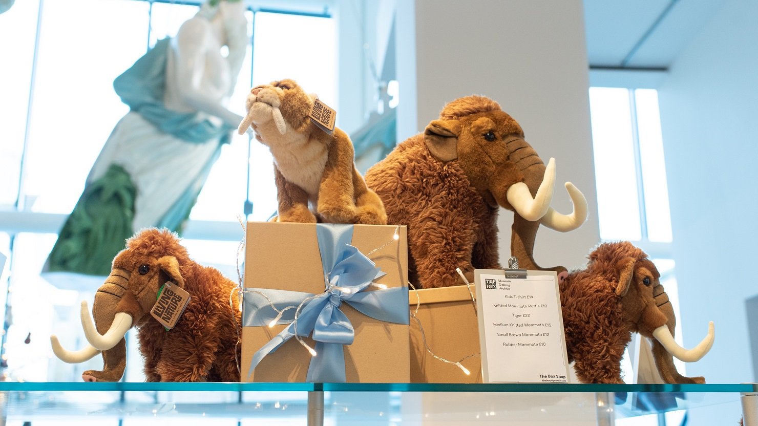 Soft toy mammoths on display in a shop