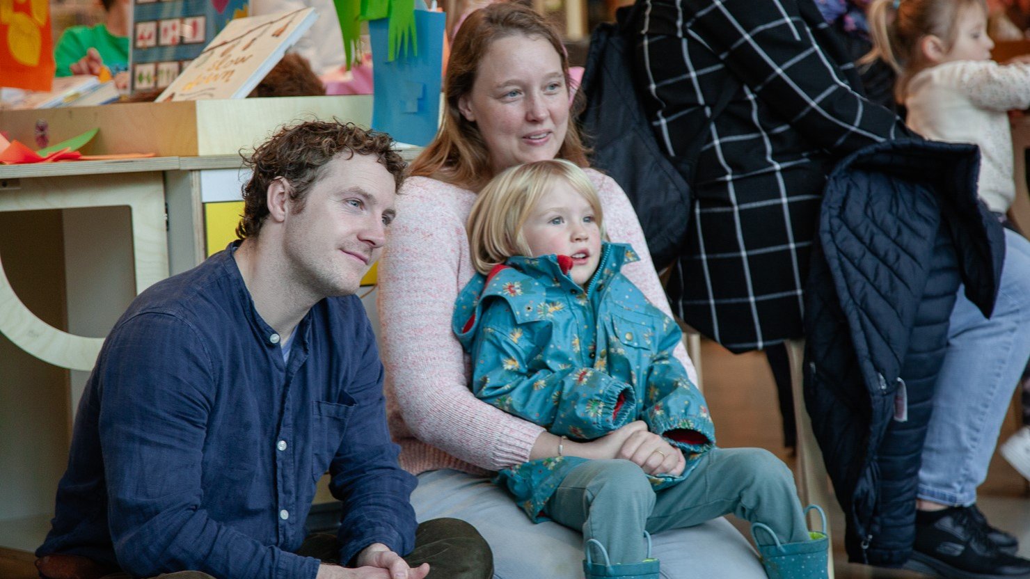 A family sat on the floor listening to a story