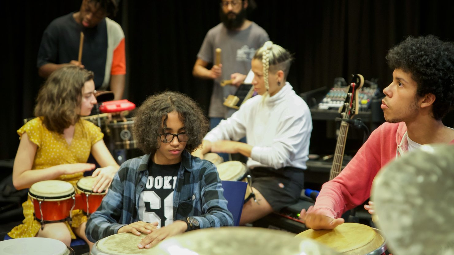 Photograph of a group of young people playing musical instruments