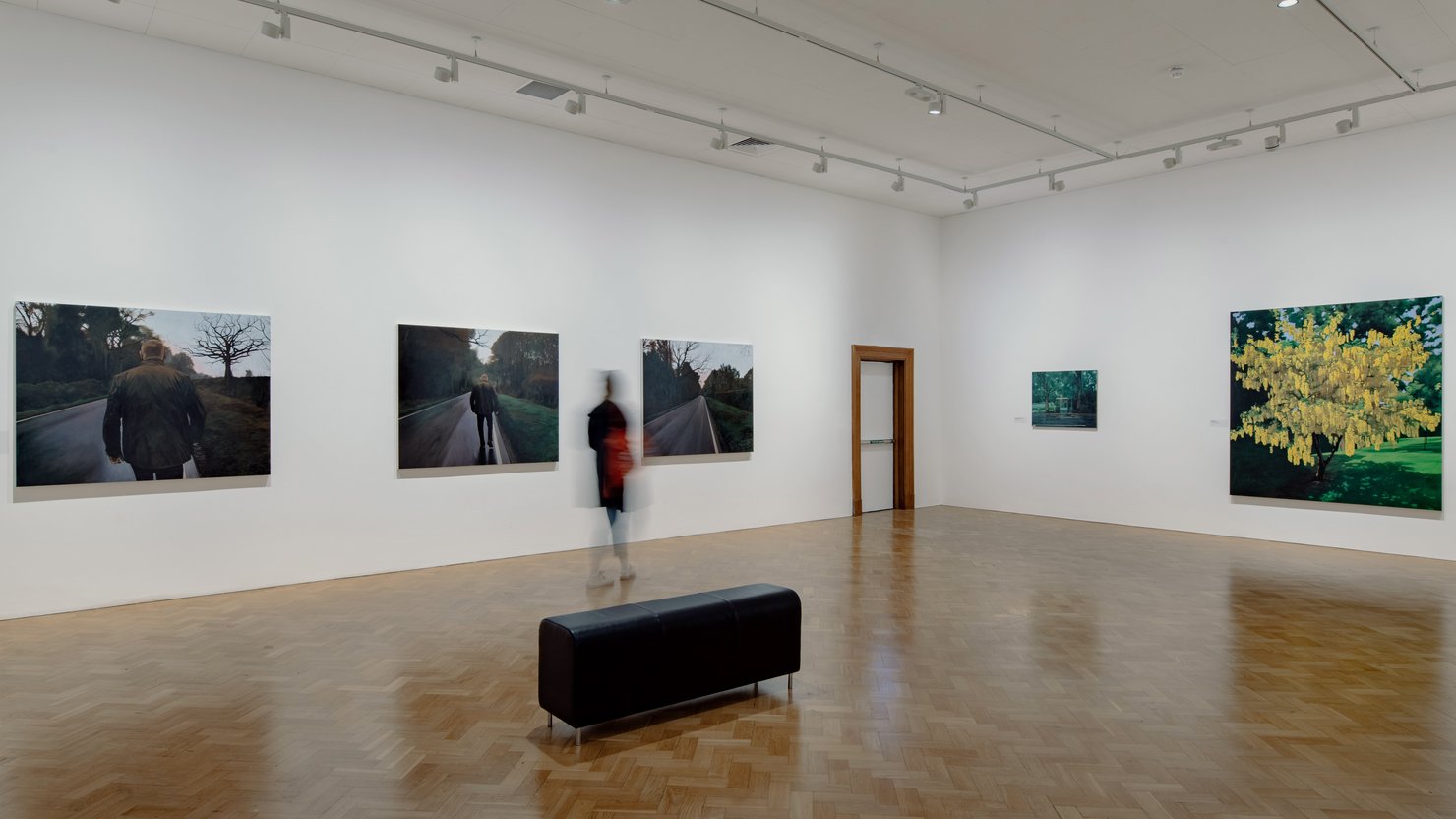 George Shaw artwork grouped on two walls in gallery
