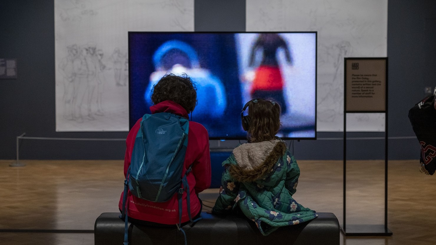 Two people watching Hannah Quinlan and Rosie Hastings, Gaby, 2018. Photo by Dom Moore.