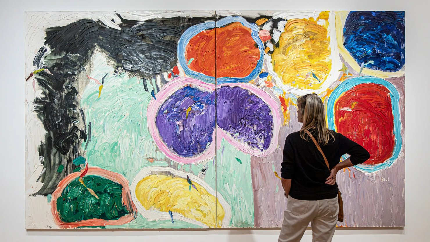 Photograph showing a woman looking at a huge abstract work in a gallery