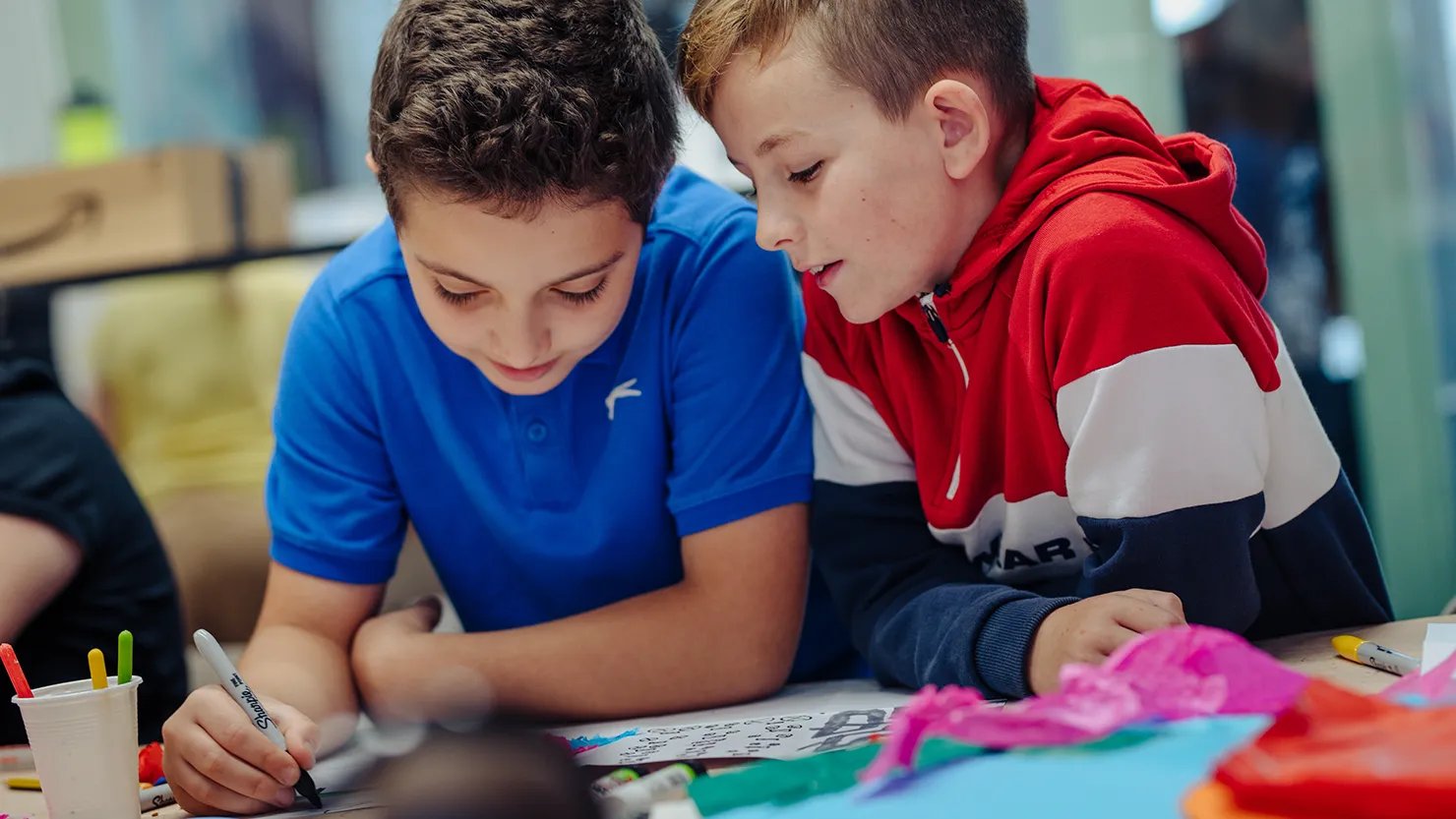 Photograph of two boys taking part in an art workshop