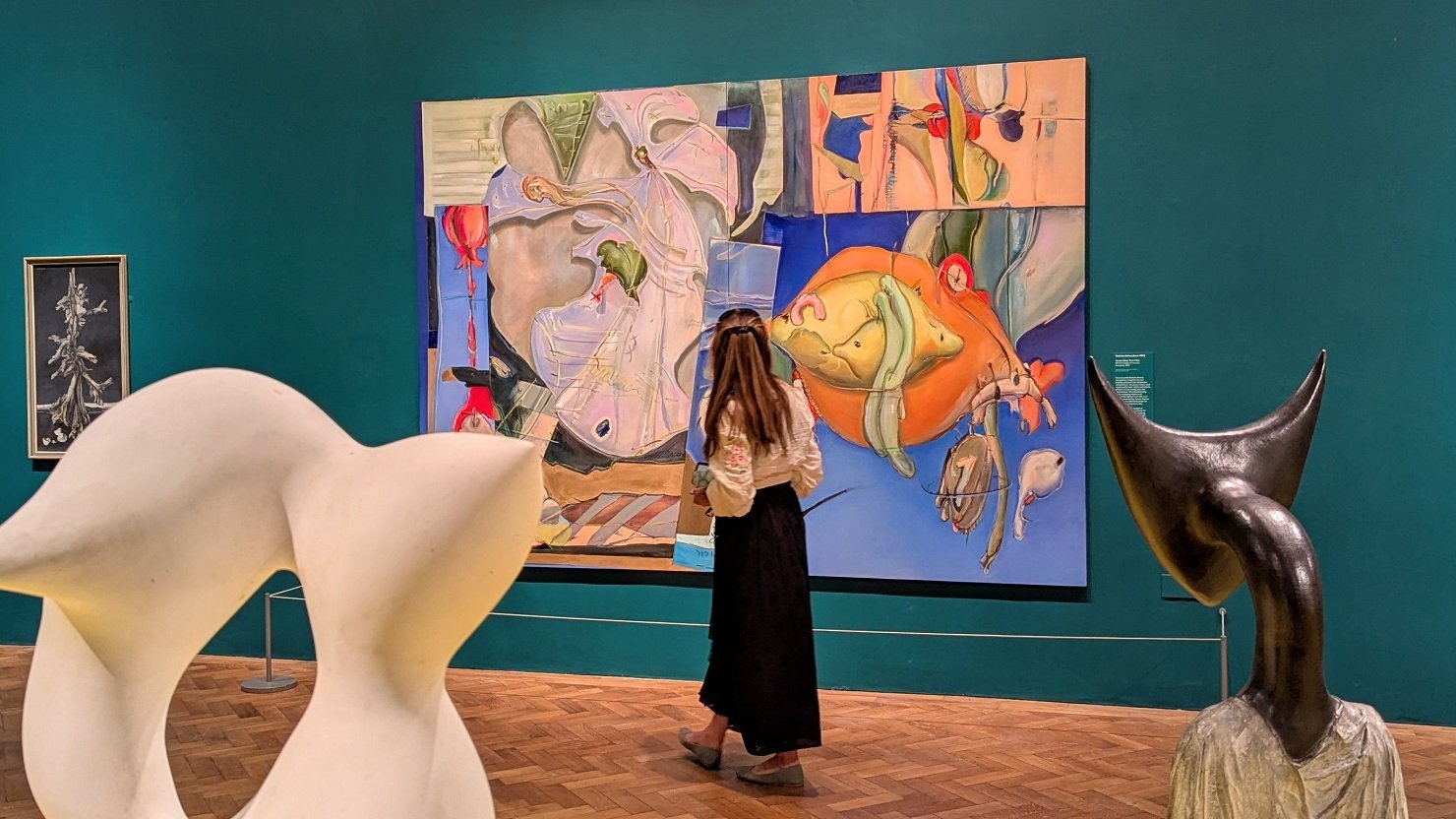 A female visitor looking at the 'Forbidden Territories' exhibition at The Box Plymouth