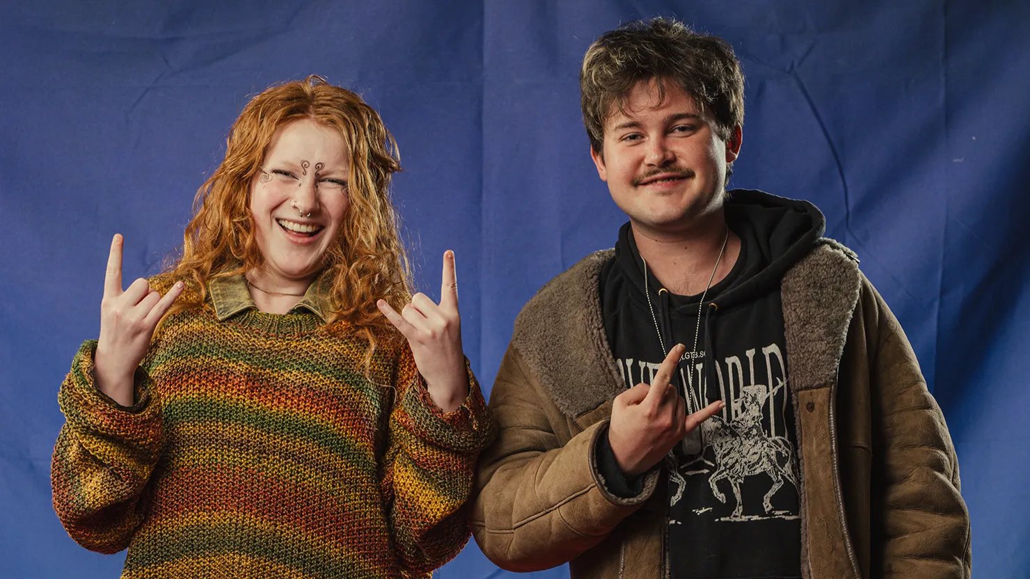 A young male and female posing for the camera