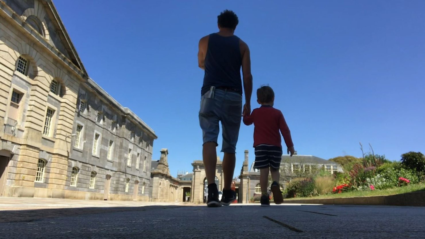 Andy Quick and his son walking through the Royal William Yard in Plymouth - June 2020