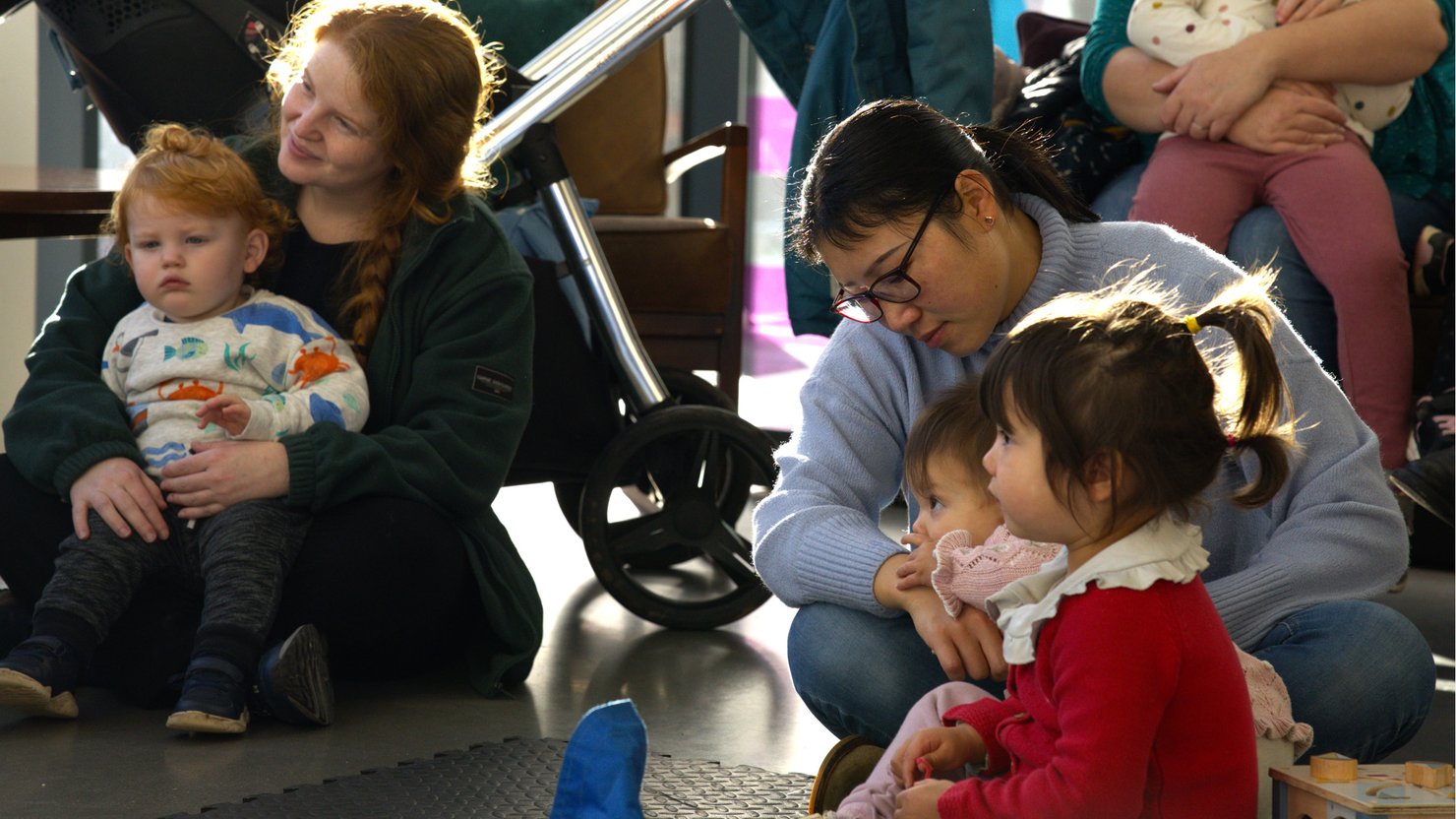 Children and adults listening to storytelling at The Box Plymouth