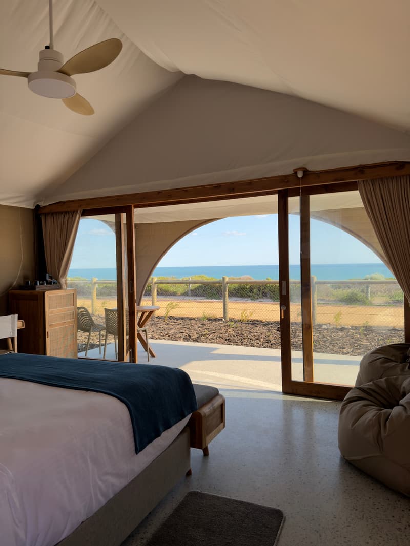 Safari tent bedroom opening to the ocean, beachfront resort, Perth