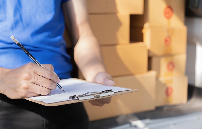 Image of person holding a clipboard and pencil