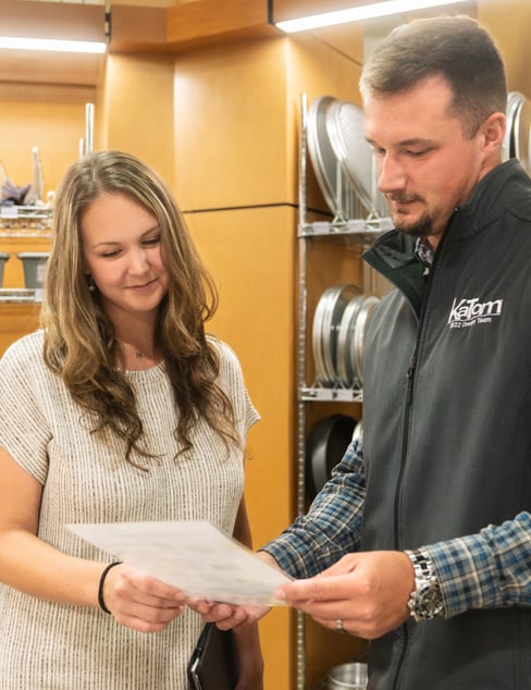 Picture of a KaTom employee looking at a paper with customer