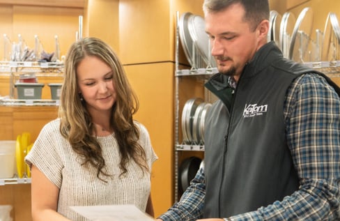Picture of a KaTom employee looking at a paper with customer