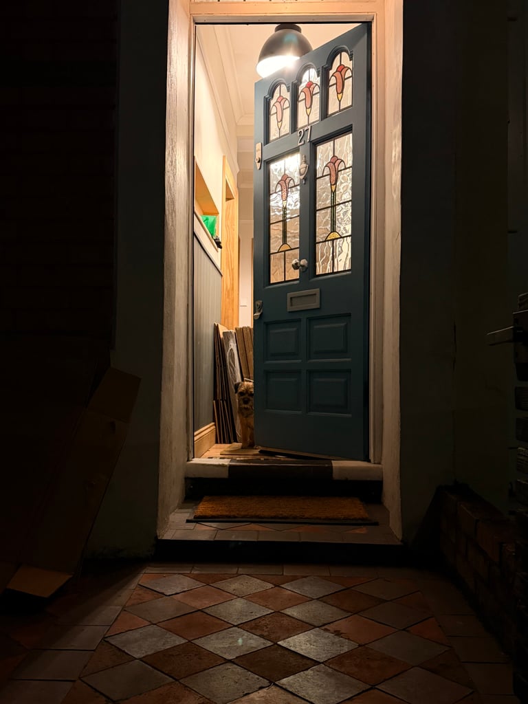 Maude peeking out of the front door.