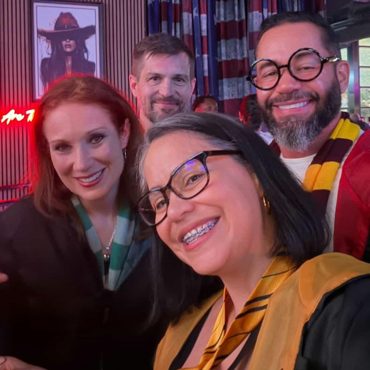 Wizards Night Out crew of four in round specs and house scarves squeeze in for a spellbound group selfie