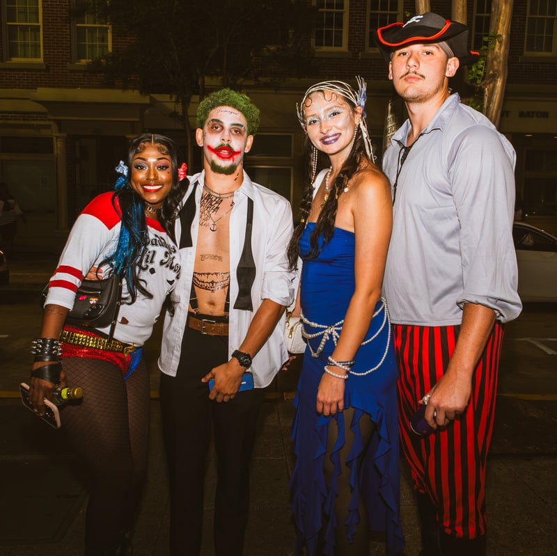 Wide shot of a costumed crowd downtown at night