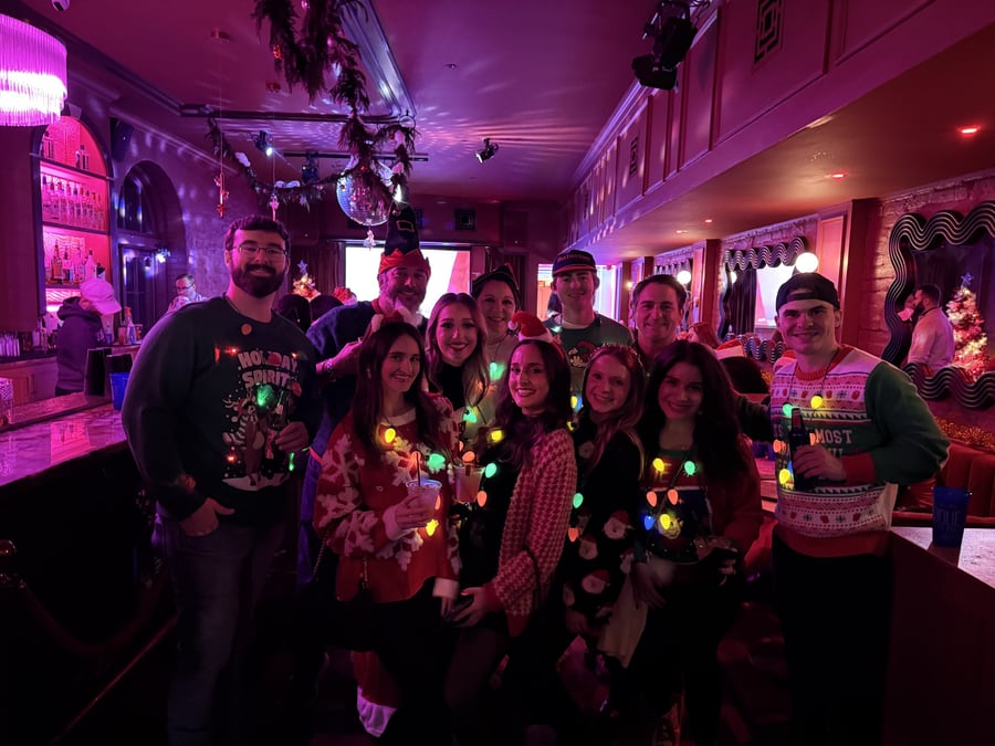Bad Santa Pub Crawl crowd in ugly sweaters and Christmas lights