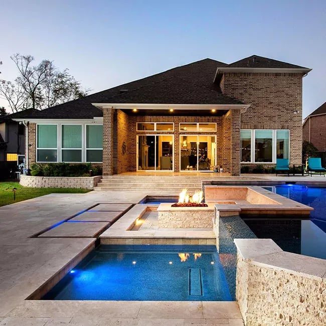 A picture of ivory travertine pavers around a pool in Melbourne.