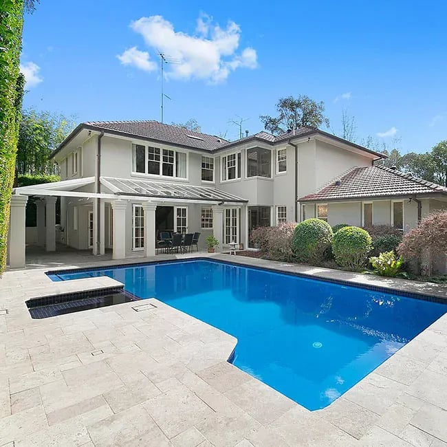 A picture of travertine pavers around a pool in Melbourne.