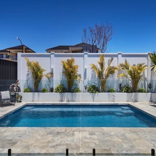 silver travertine pavers and coping tiles around a swimming pool