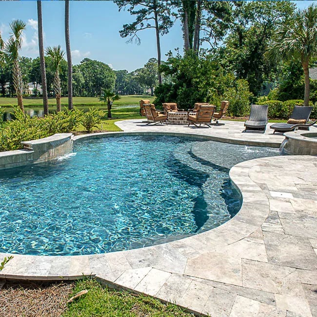 A picture of travertine pavers around a pool in Melbourne.