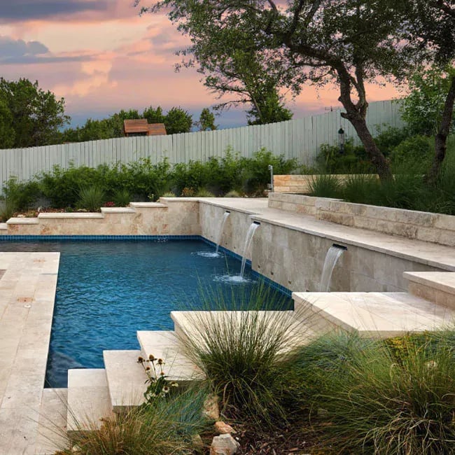 A picture of travertine pavers around a pool in Melbourne.