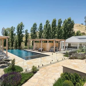 A picture of sandstone crazy paving around a pool in Melbourne.