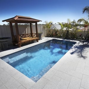 A picture of White Granite pavers around a pool in Melbourne.