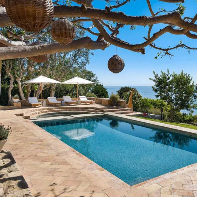 A picture of travertine pavers around a pool in Melbourne.