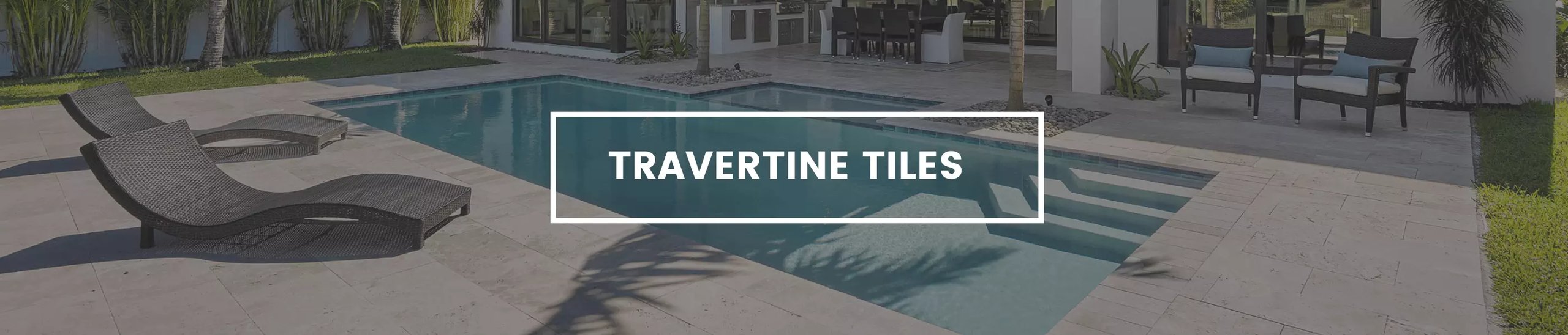Travertine tiles banner, with travertine pavers around a pool.